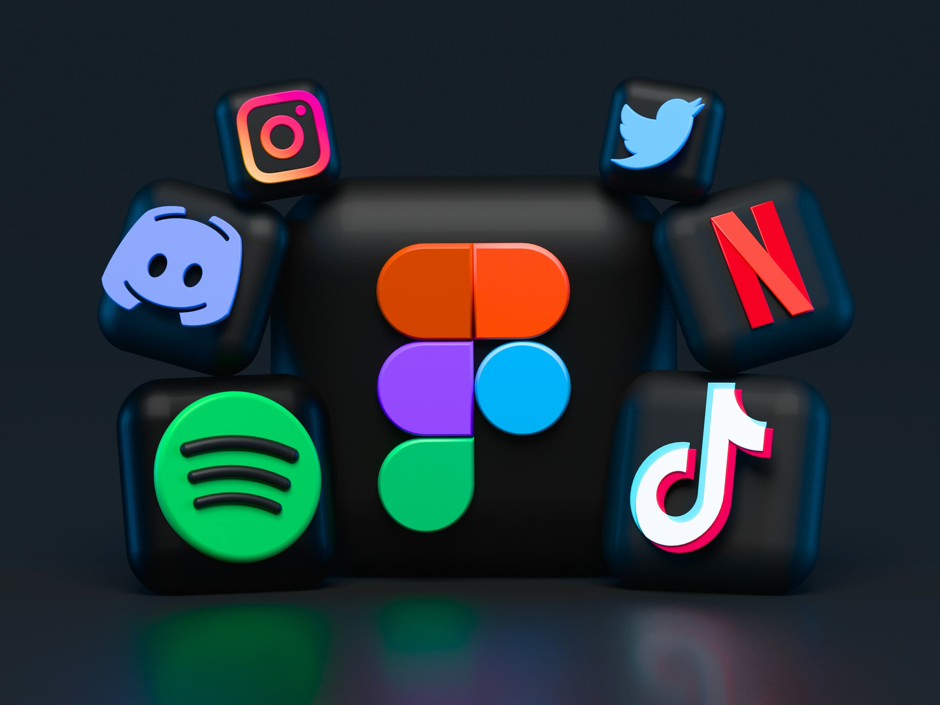 Designer working on laptop with creative materials
